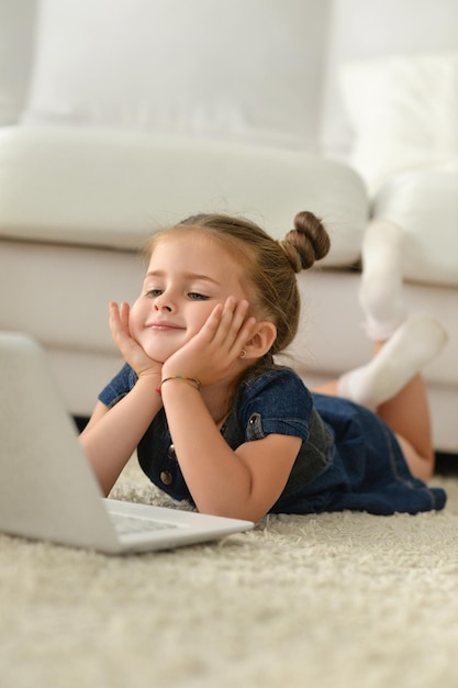 Portrait of cute little girl with laptop