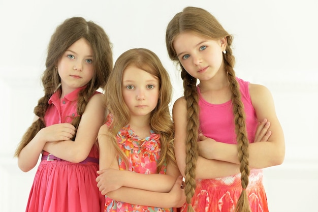 Portrait of cute little girls posing in studio