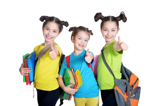 Portrait of cute little girls with book posing in studio