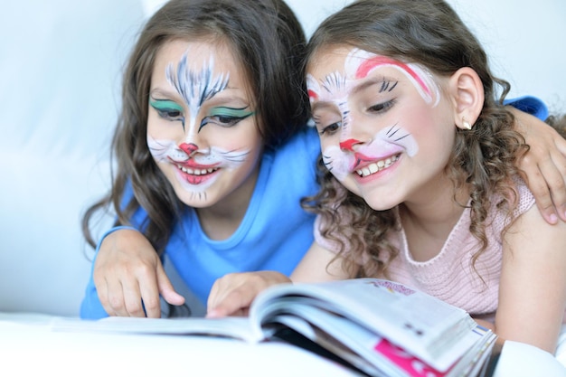 Portrait of cute little girls with faces painted