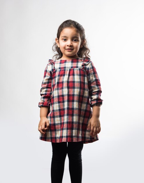 Portrait of cute little Indian girl model, standing isolated over white background