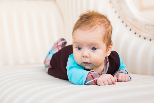 A portrait of a cute newborn baby laughing