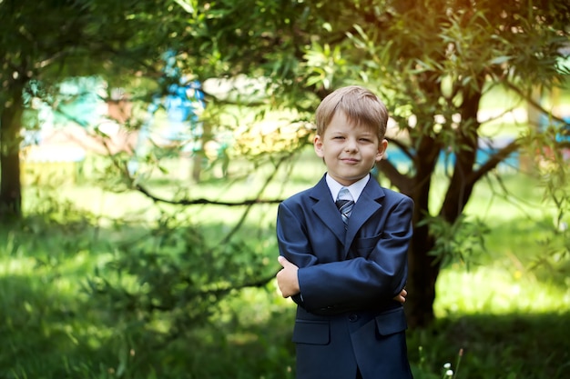 Portrait of cute school boy with backpack outdoors