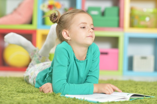 Portrait of cute schoolgirl studying at home