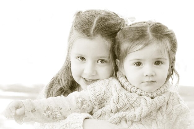 Photo portrait of cute siblings at home