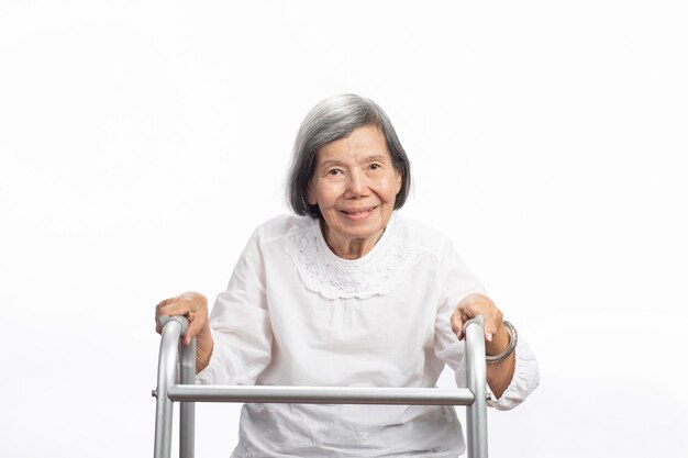 Portrait of a cute smiling elderly asian woman looking at camera isolated on white. mature old lady close up portrait.