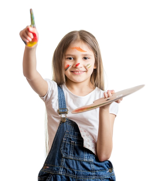 Portrait of cute smiling girl with painted face posing with paint palette