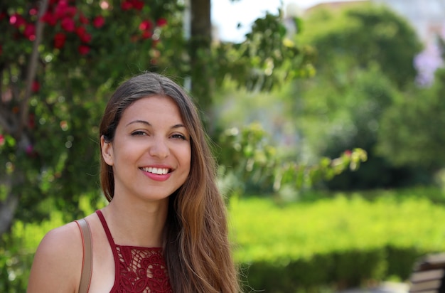 Portrait of cute smiling woman  in the park