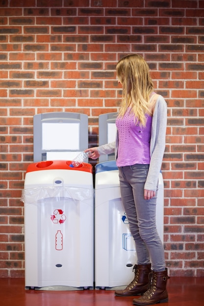 Portrait of a cute student recycling