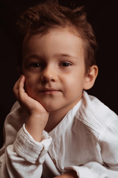 Photo portrait of a cute thoughtful child a preschooler boy