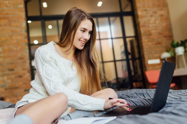 Portrait of cute woman have a nive weekend time in luxury apartment with her laptop