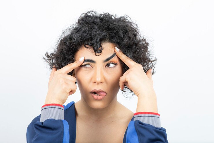 Photo portrait of a cute woman with curly hair doing funny face .
