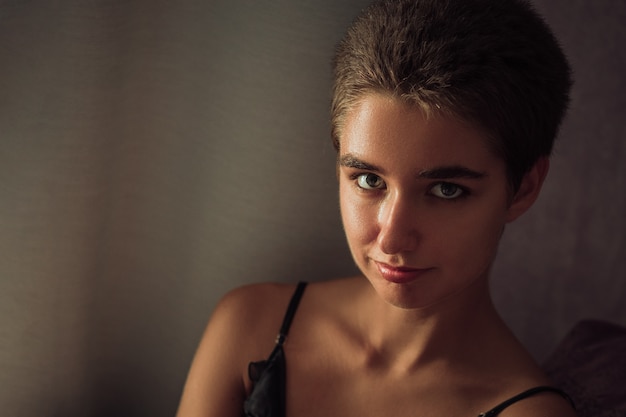 Portrait of a cute woman with short hair , posing at home