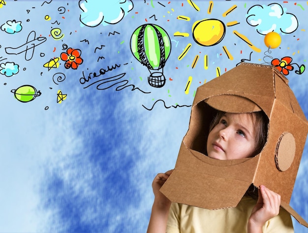 Photo portrait of cute young boy in mask thinking over blue background