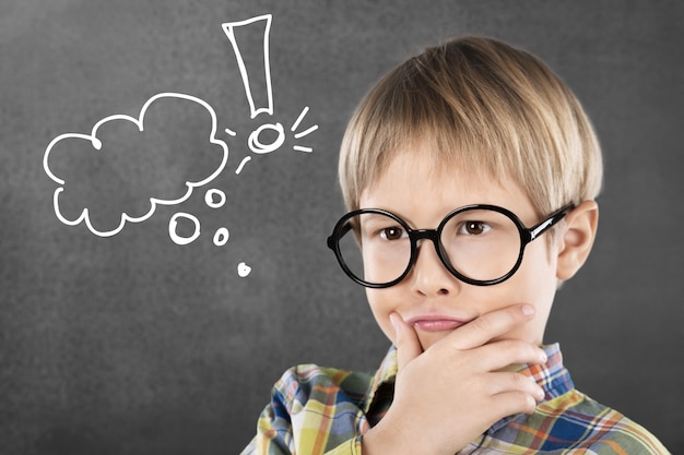 Portrait of a cute young boy with glasses isolated on  background. Studio shot.