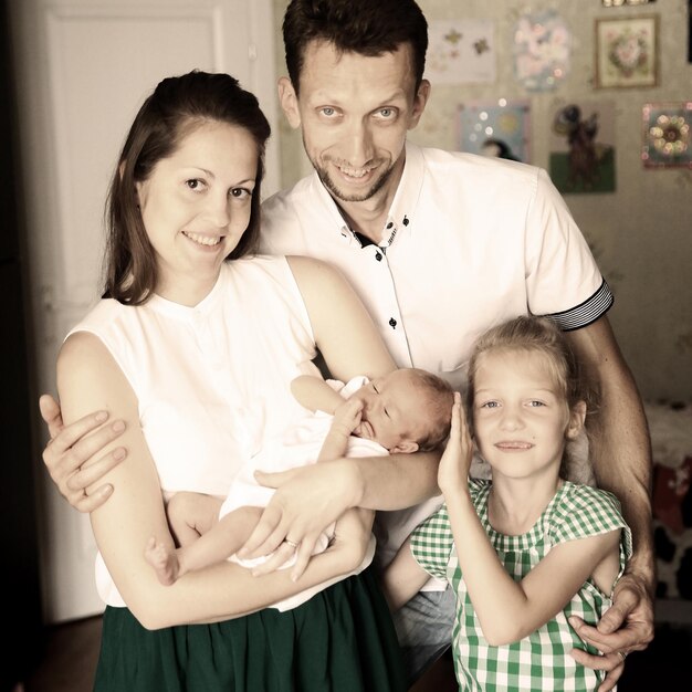 Portrait daddaughter and mom with a newborn baby