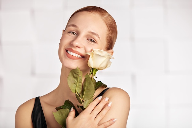 Portrait of a dark blond lady with a gentle makeup the girl is wearing golden stud earrings made out