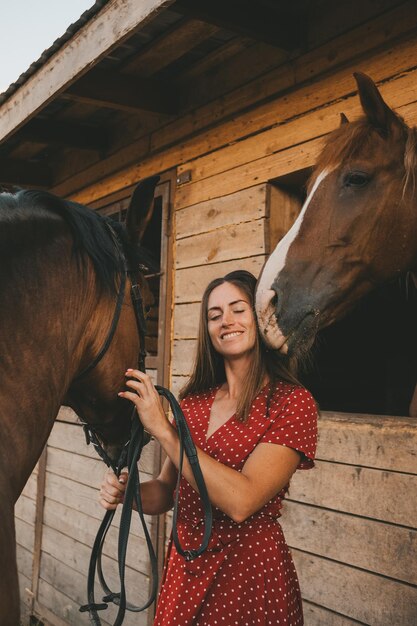 portrait of a dark-haired girl and  two horses