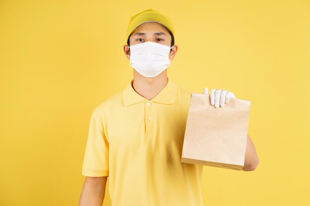 Portrait of delivery male holding shopping bags