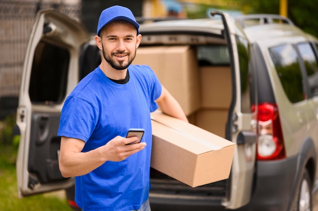 Portrait of delivery man carrying parcel