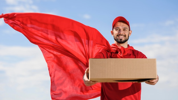 Photo portrait of delivery man wearing superhero cape