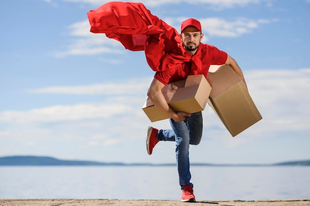 Portrait of delivery man wearing superhero cape