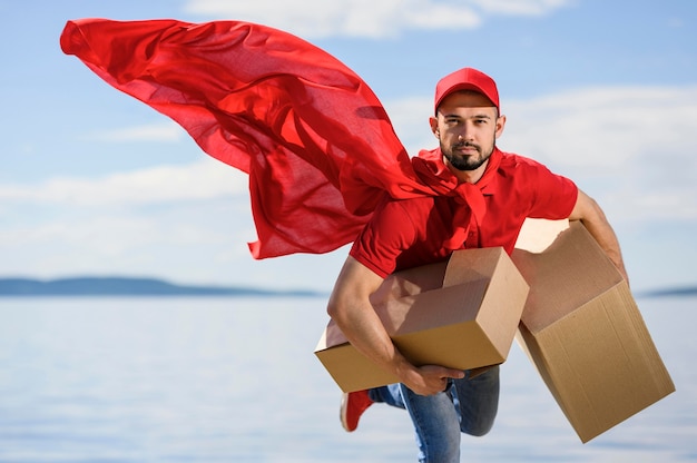 Photo portrait of delivery man wearing superhero cape