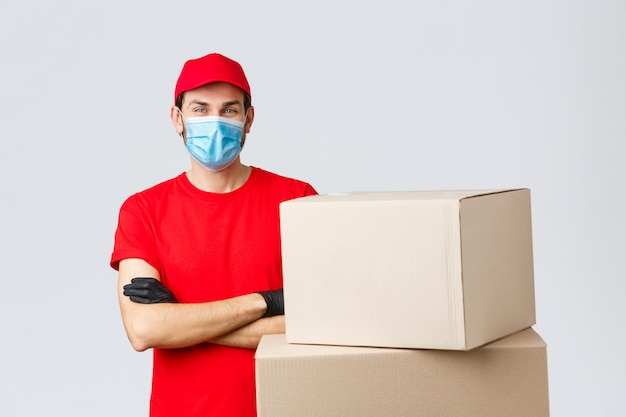 Portrait of delivery man with face mask and boxes