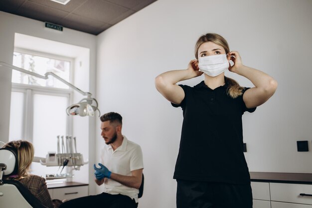 Portrait of a dental assistant smiling with dentistry work in the background