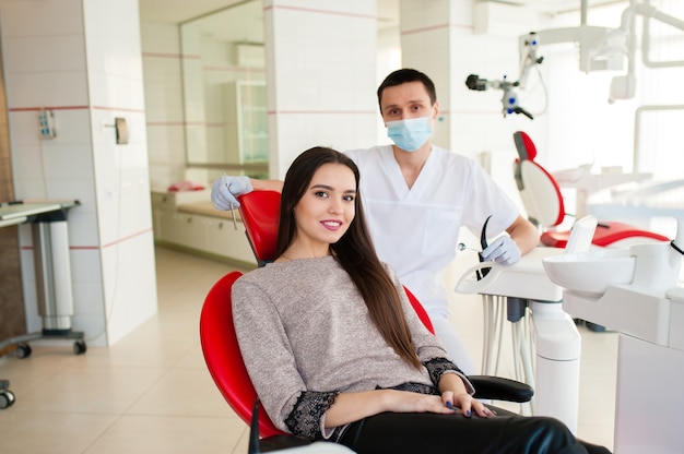 Portrait of dentist examining patient in dental clinic.