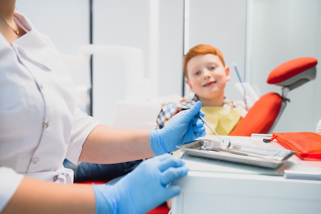 Portrait of a dentist holding dental instruments in his hands in the clinic close-up