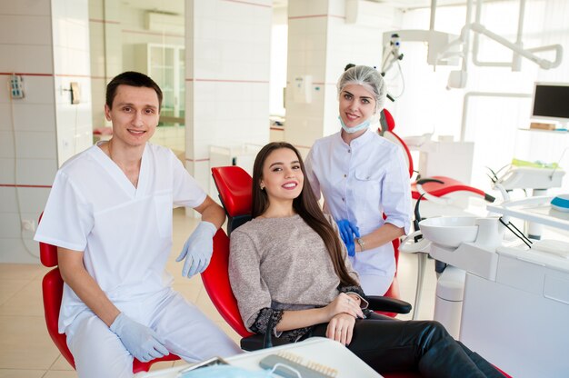 Portrait of dentists and happy girl.