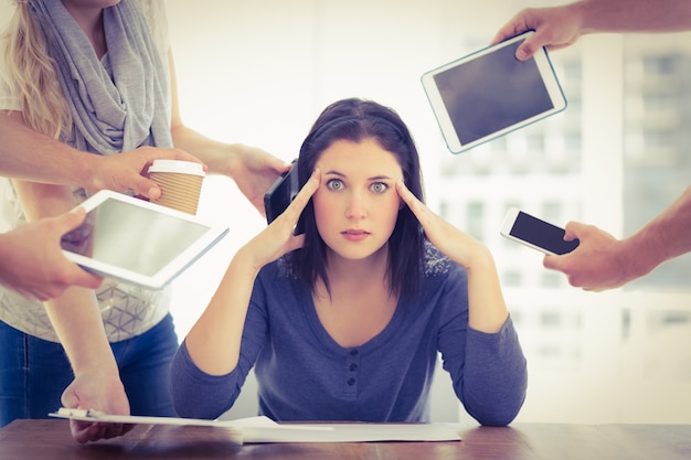 portrait of depressed businesswoman with head in hand 