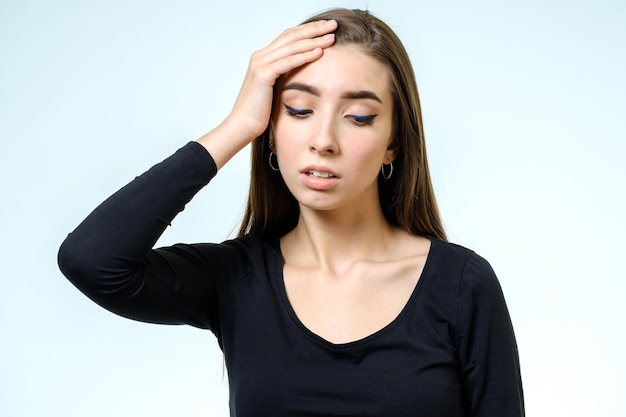 Portrait of depressed woman touching her head