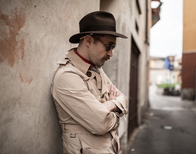 Portrait of a detective near an old wall