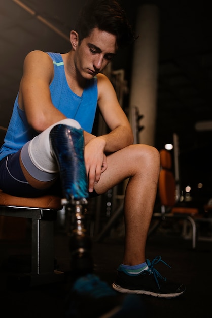 Portrait of disabled young in the gym. Disabled sportsman Concept.