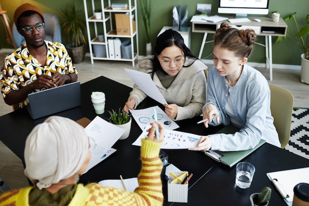 Portrait of diverse creative team collaborating at business meeting and brainstorming ideas