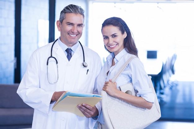 Portrait of doctor and colleague smiling in hospital