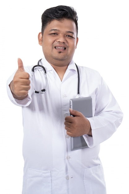 Portrait of a doctor look at the camera smile and holding tab with thumb up