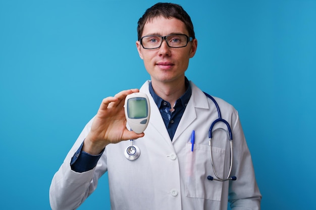 Portrait of doctor with stethoscope and blood glucose meterin his hand