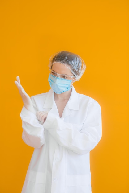 Portrait of a doctor a young woman in a protective medical mask on her face