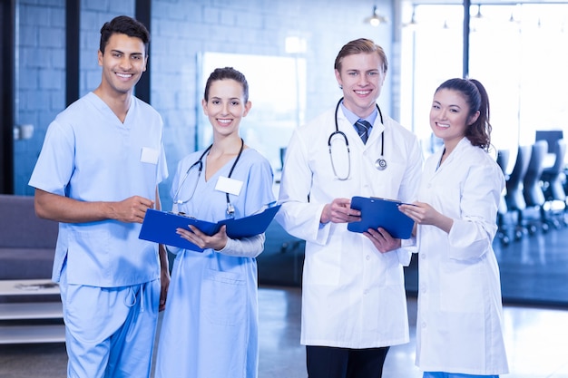 Portrait of doctors looking at medical report and smiling