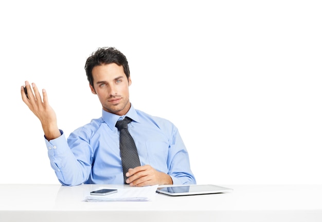 Portrait documents and mockup with an annoyed businessman sitting in studio isolated on a white background Review gesture and a frustrated male employee working at his desk with blank space