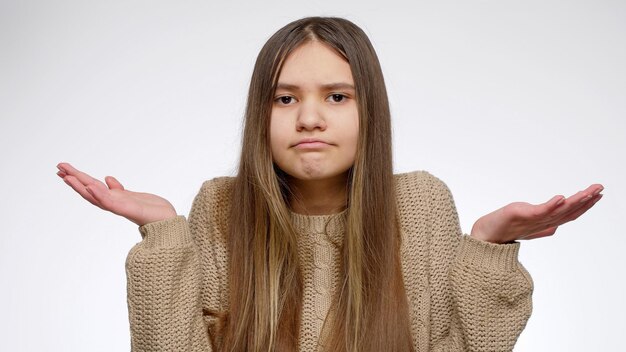 Photo portrait of doubtful girl showing confusion gesture with hands