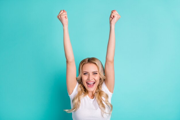 portrait of ecstatic girl enjoy sale lottery win raise fists shout