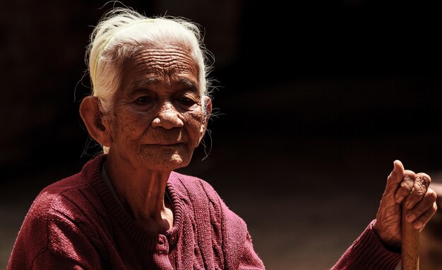 portrait of old Asian senior woman with wrinkle skin and black