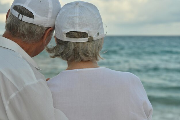 Portrait of elderly couple on beach Travel Back view