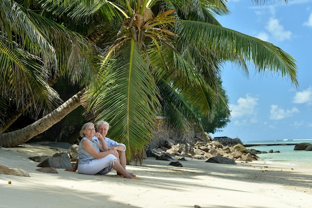 Portrait of elderly couple resting on beach Travel