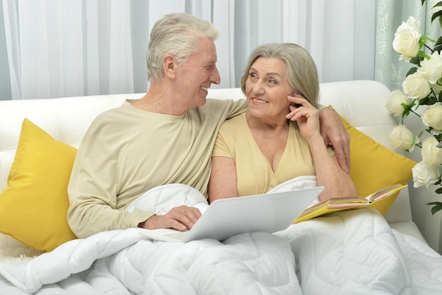 portrait of an elderly couple with a laptop