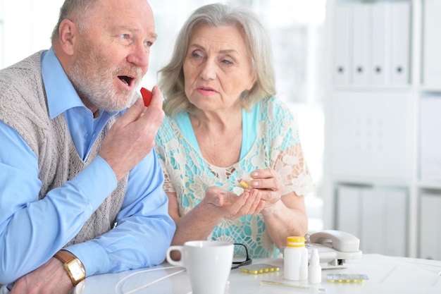 Portrait of an elderly couple with pills